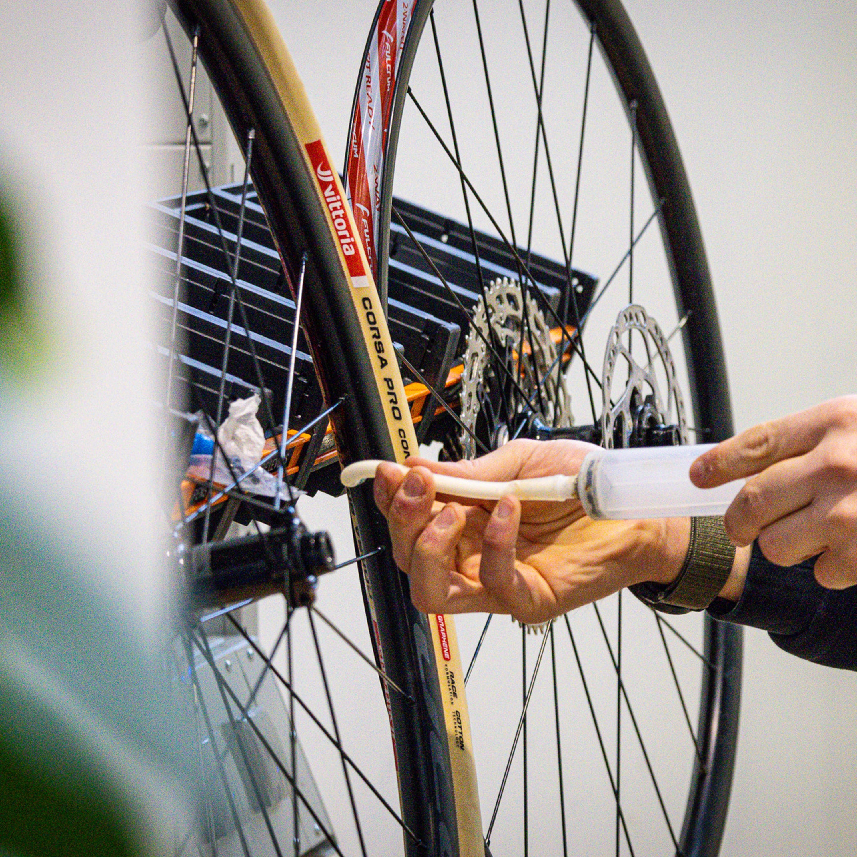 Hand installing Vittoria Corsa Pro Control Tubeless-Ready road bike tire on wheel