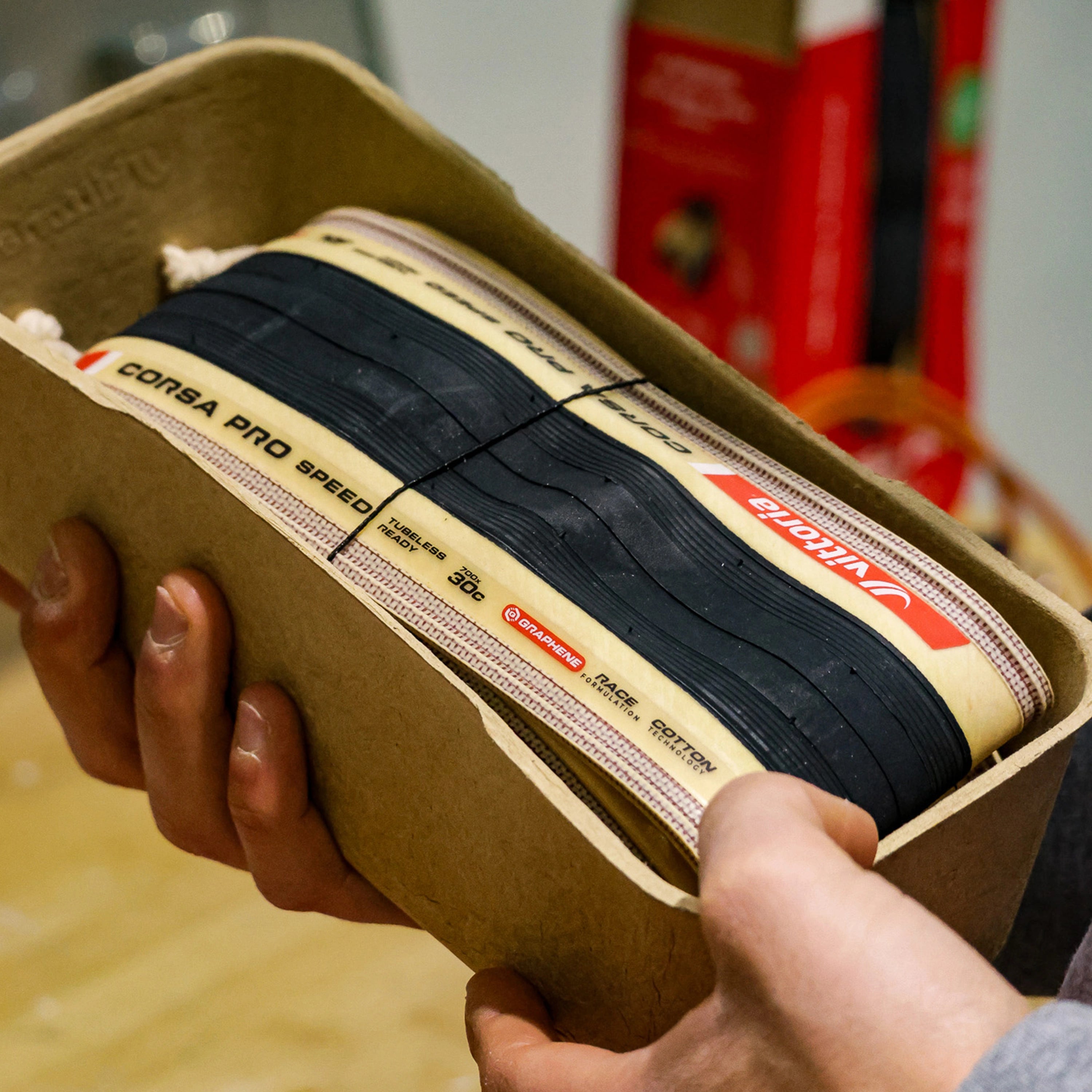 Hand holding Vittoria Corsa Pro Speed Tubeless-Ready road bike tire